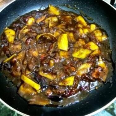 Traditional Odia Karamanga Khatta sweet star fruit chutney served in a brass bowl
