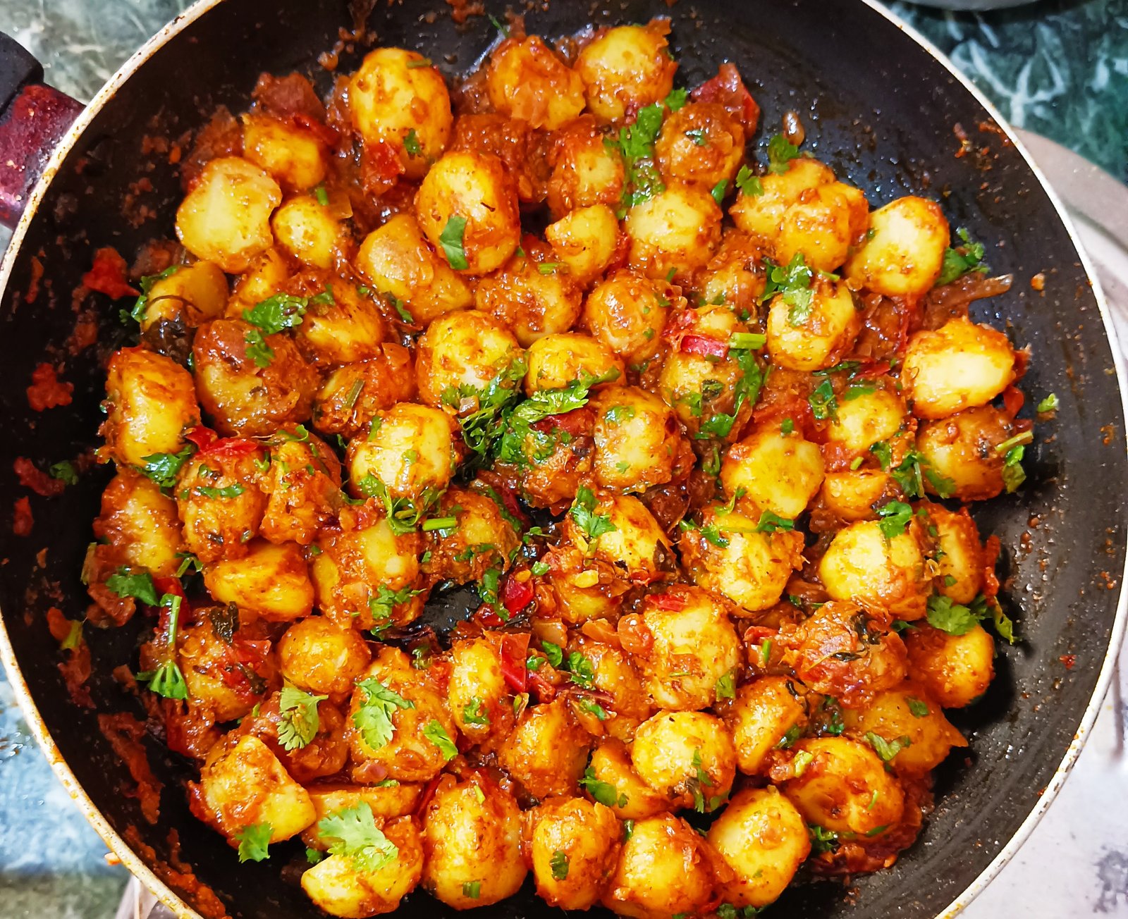 Traditional Odia Alu Dum served hot in a bowl garnished with coriander leaves